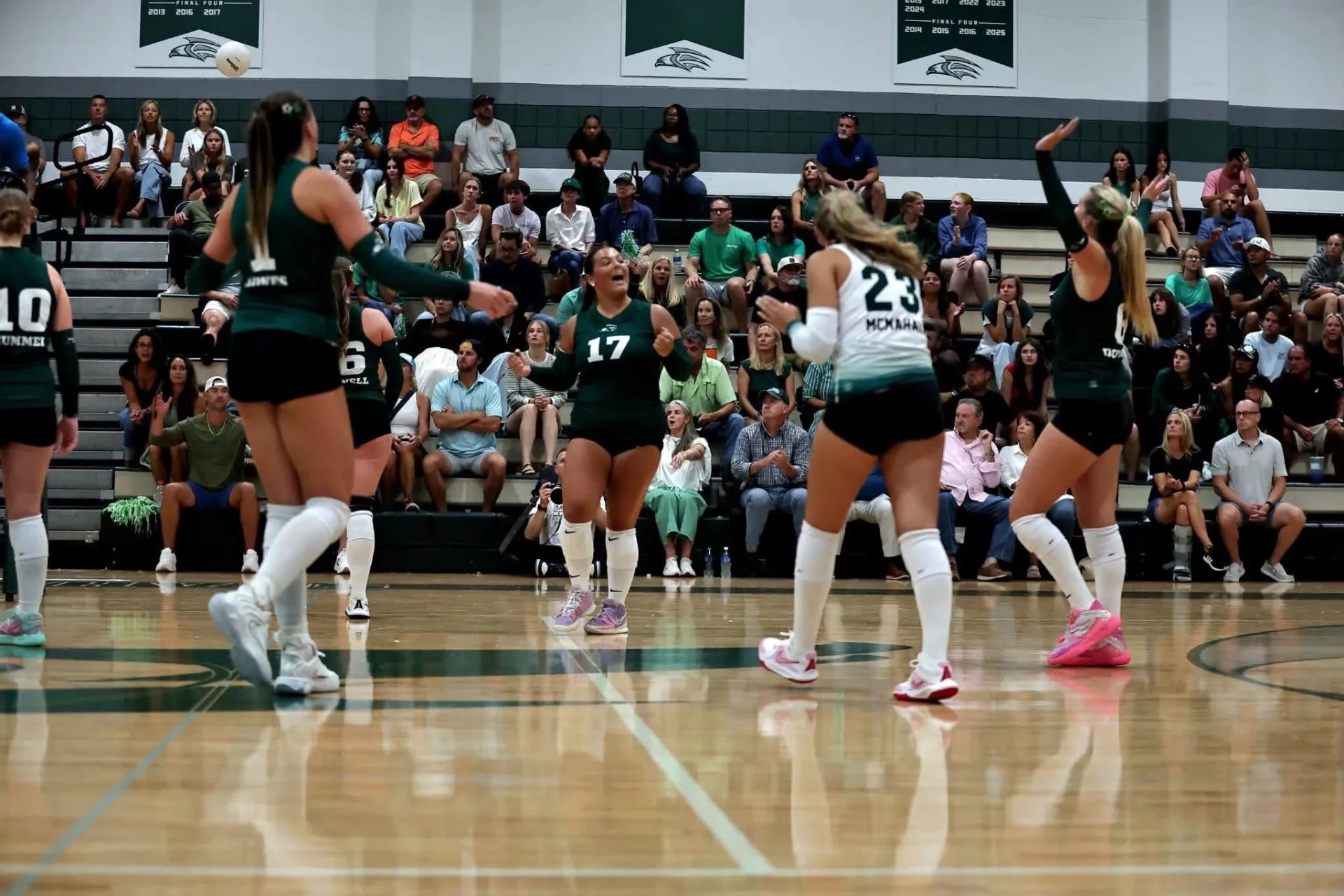 South Walton Seahawks volleyball players celebrating a point in front of a packed home crowd at South Walton High School